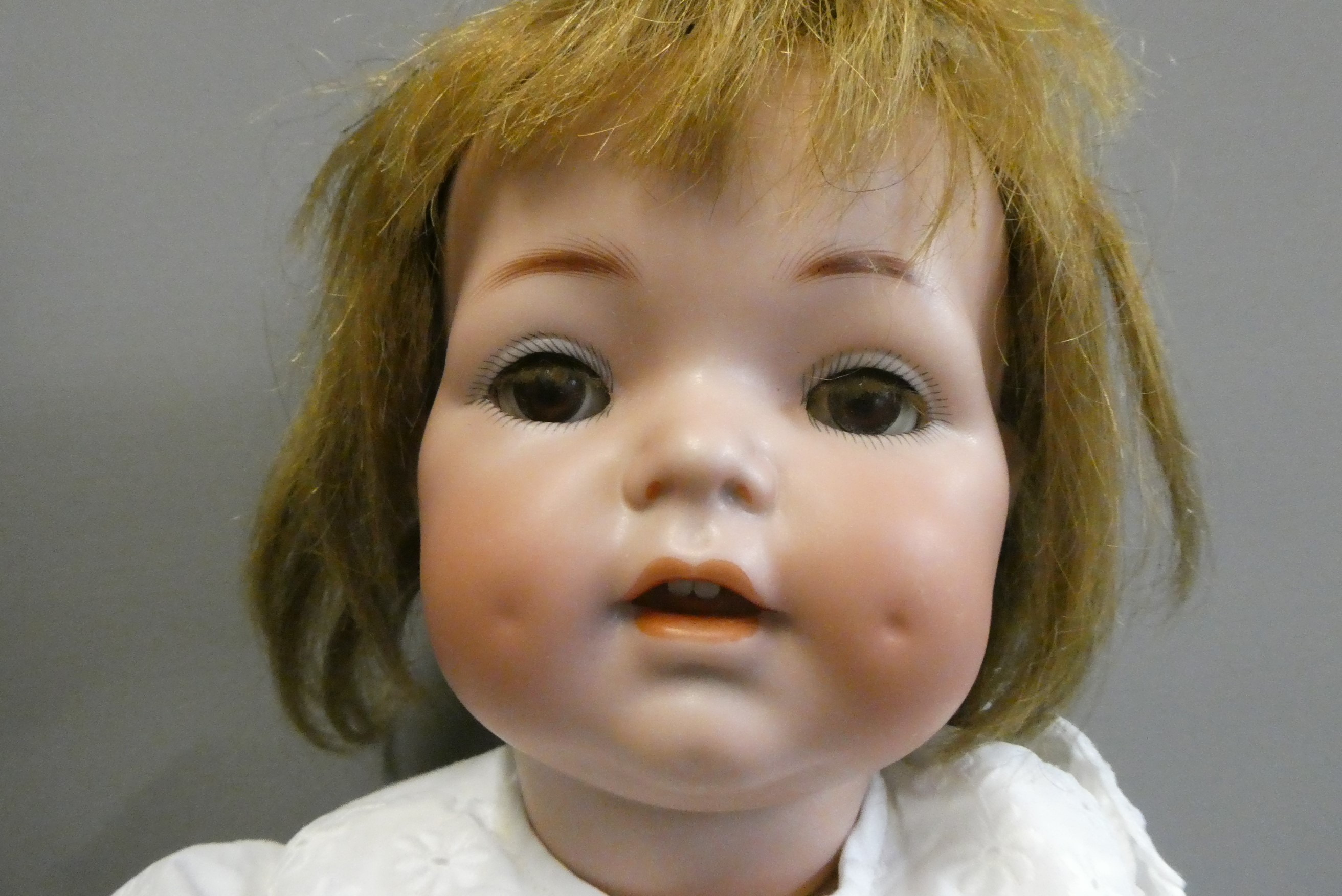 A Simon & Halbig K & R bisque socket head doll, with brown glass sleeping eyes, open mouth, applied Image