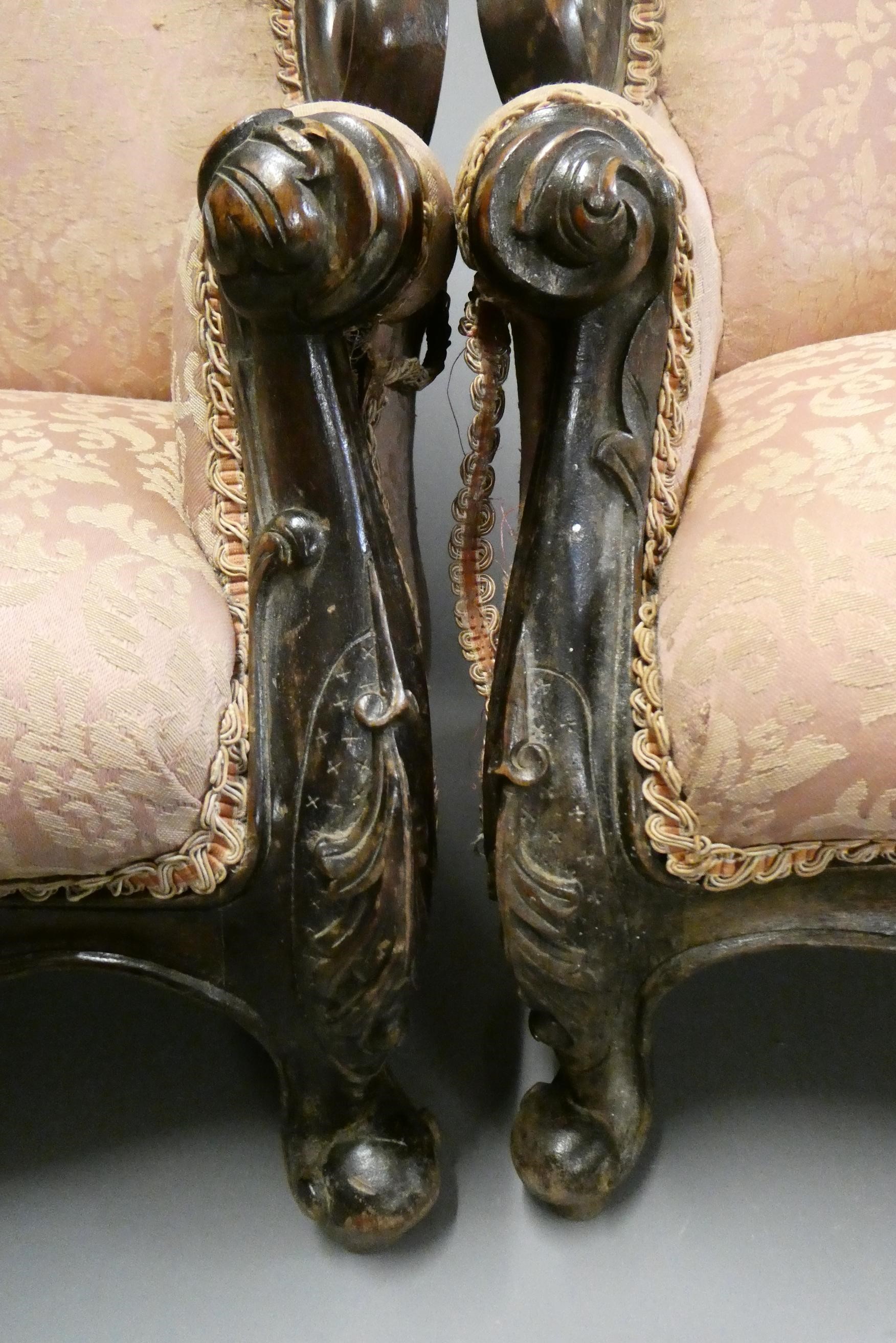 A pair of French style doll's chairs with carved wood frames, scroll arms and pink floral Image