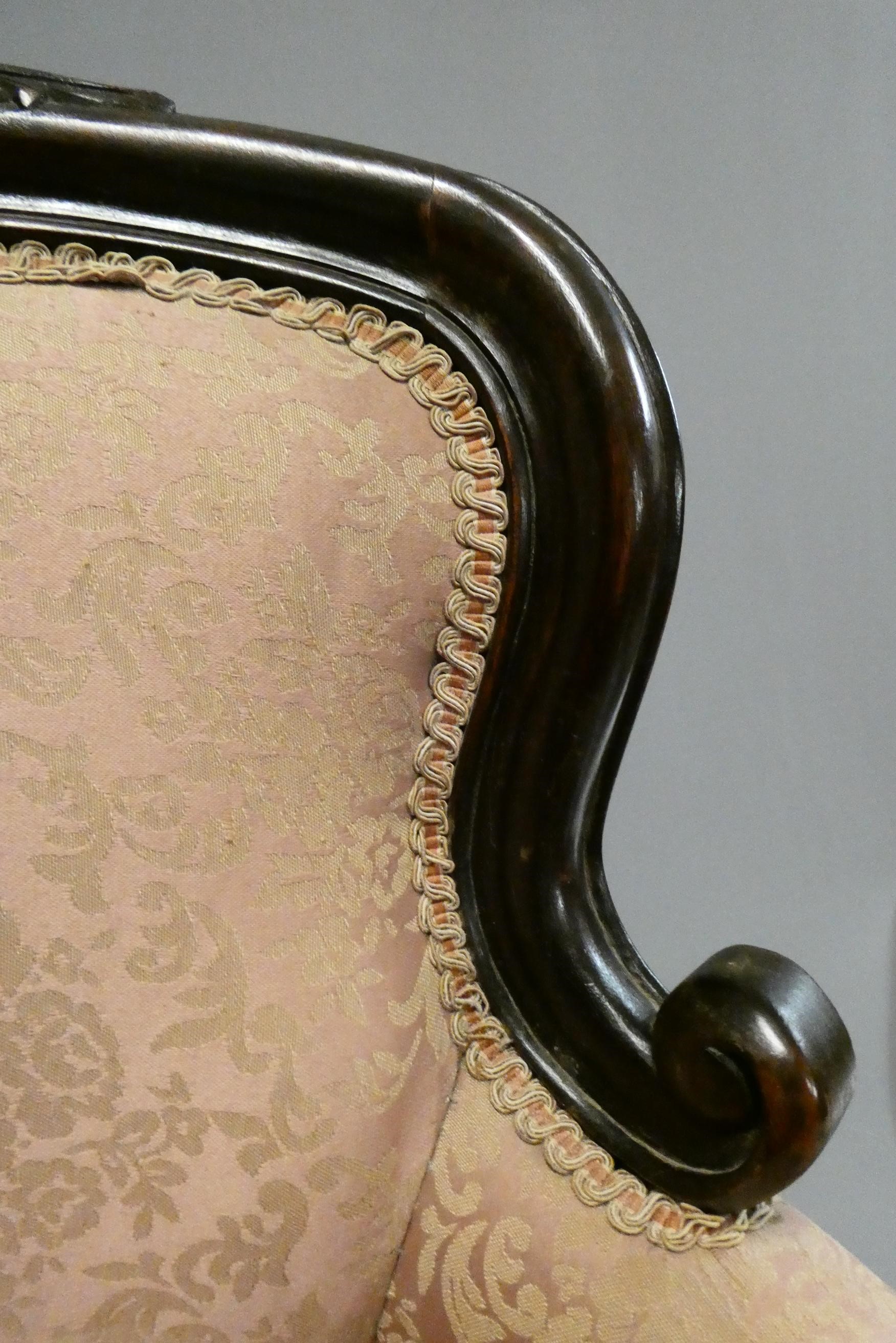 A pair of French style doll's chairs with carved wood frames, scroll arms and pink floral Image