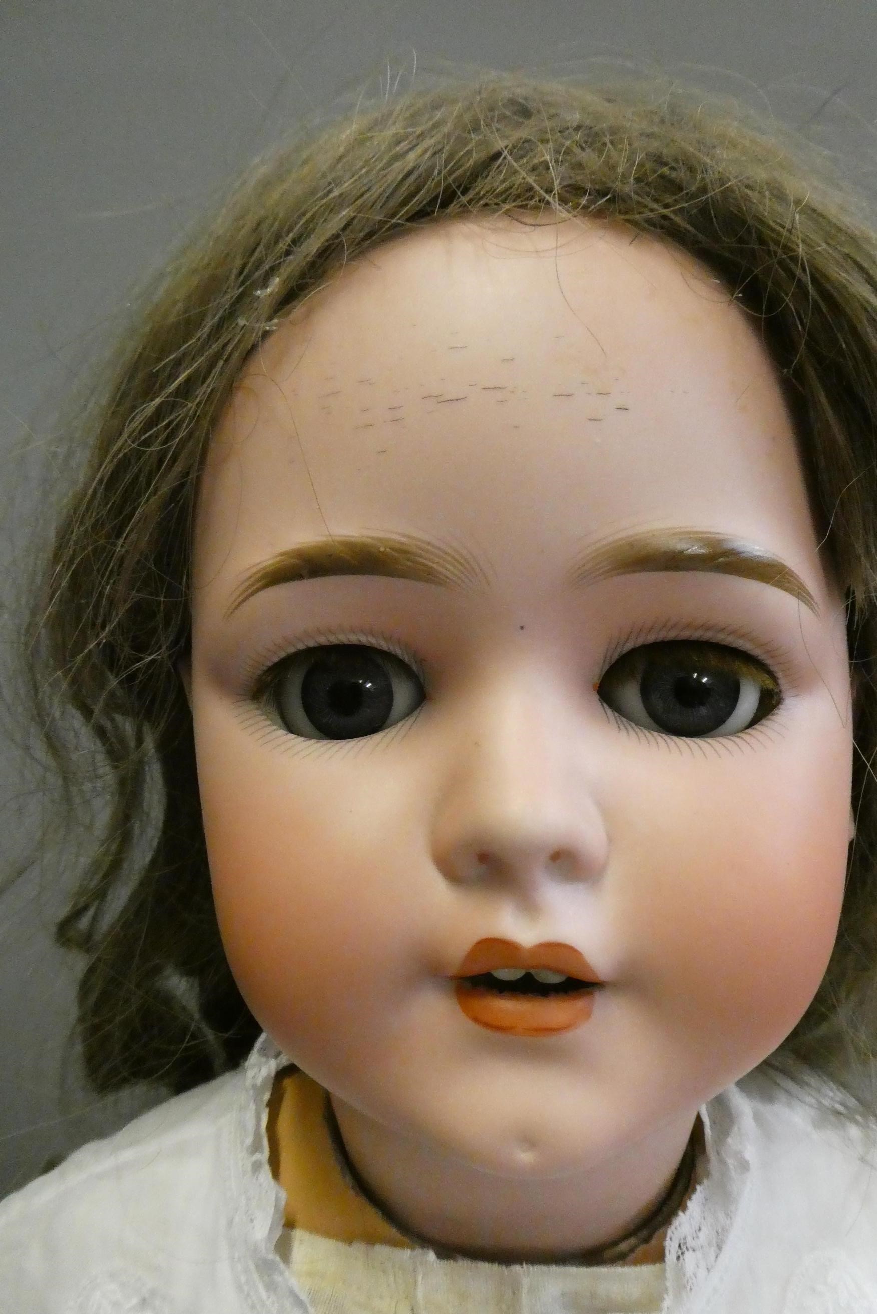 A Schoenau & Hoffmeister bisque socket head doll, with blue glass sleeping eyes, open mouth, teeth, Image