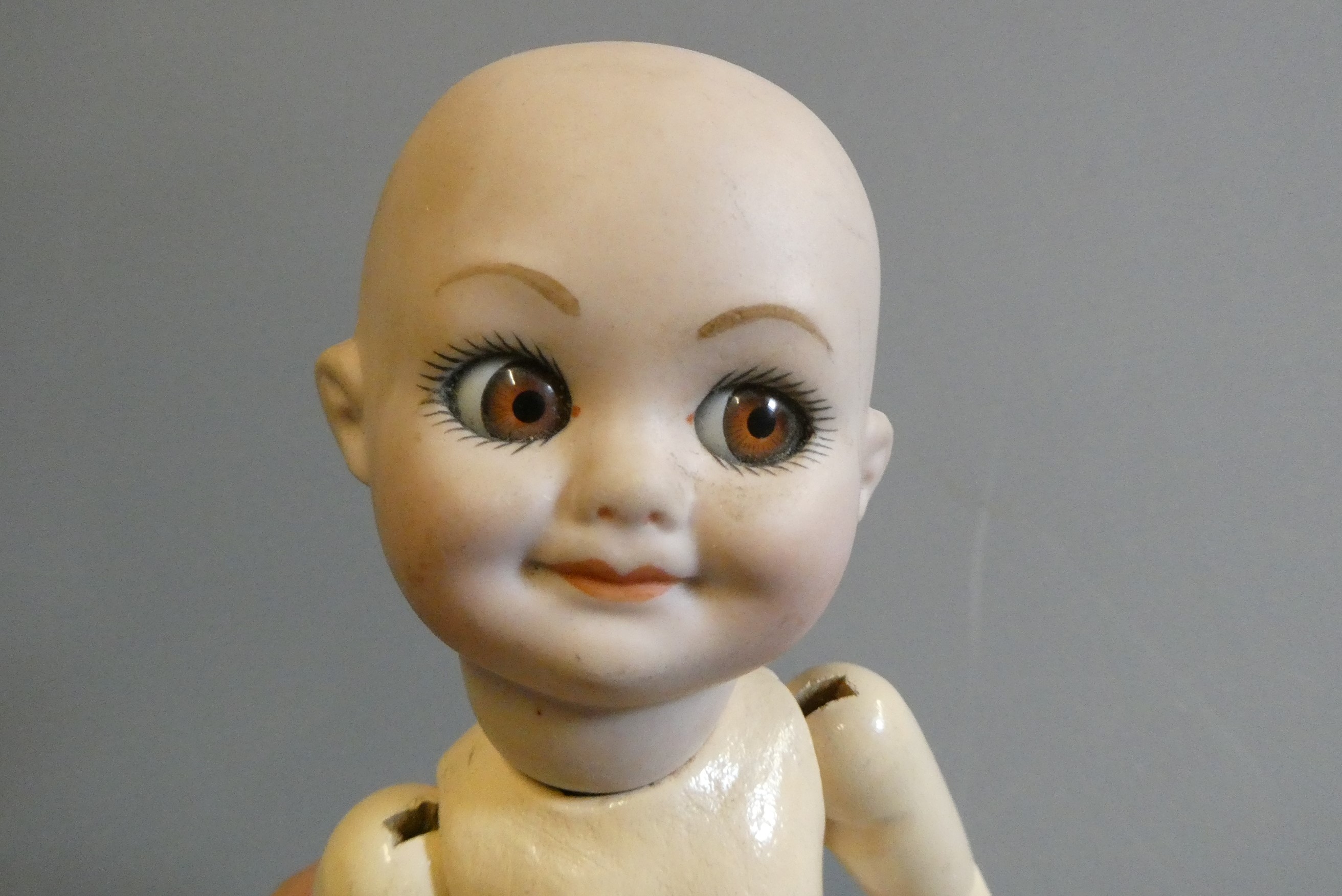 An Armand Marseille type bisque socket head character doll, with large sideways glancing glass eyes, Image