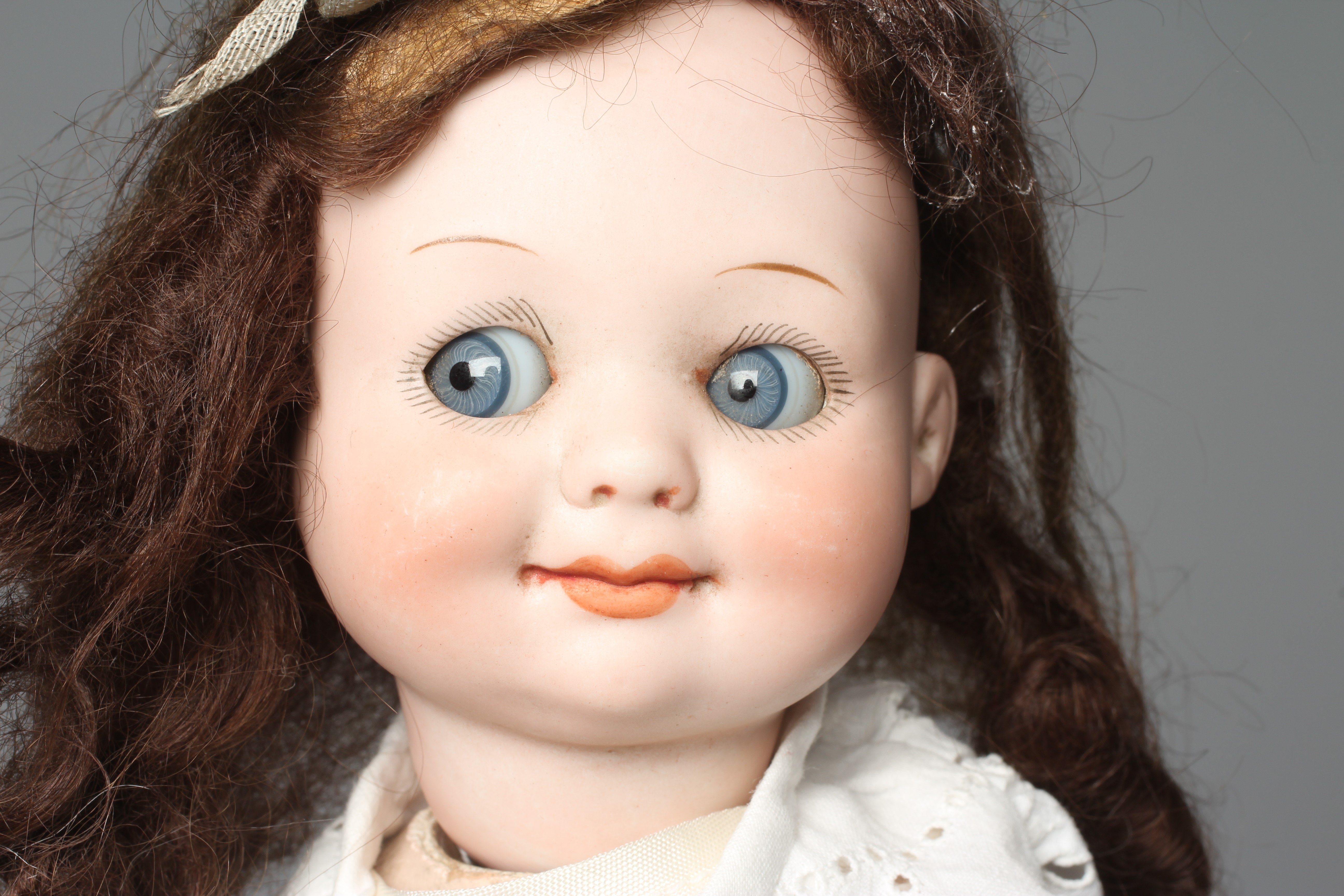 An Armand Marseille bisque socket head character doll, with sleeping sideways glancing "googly" Image