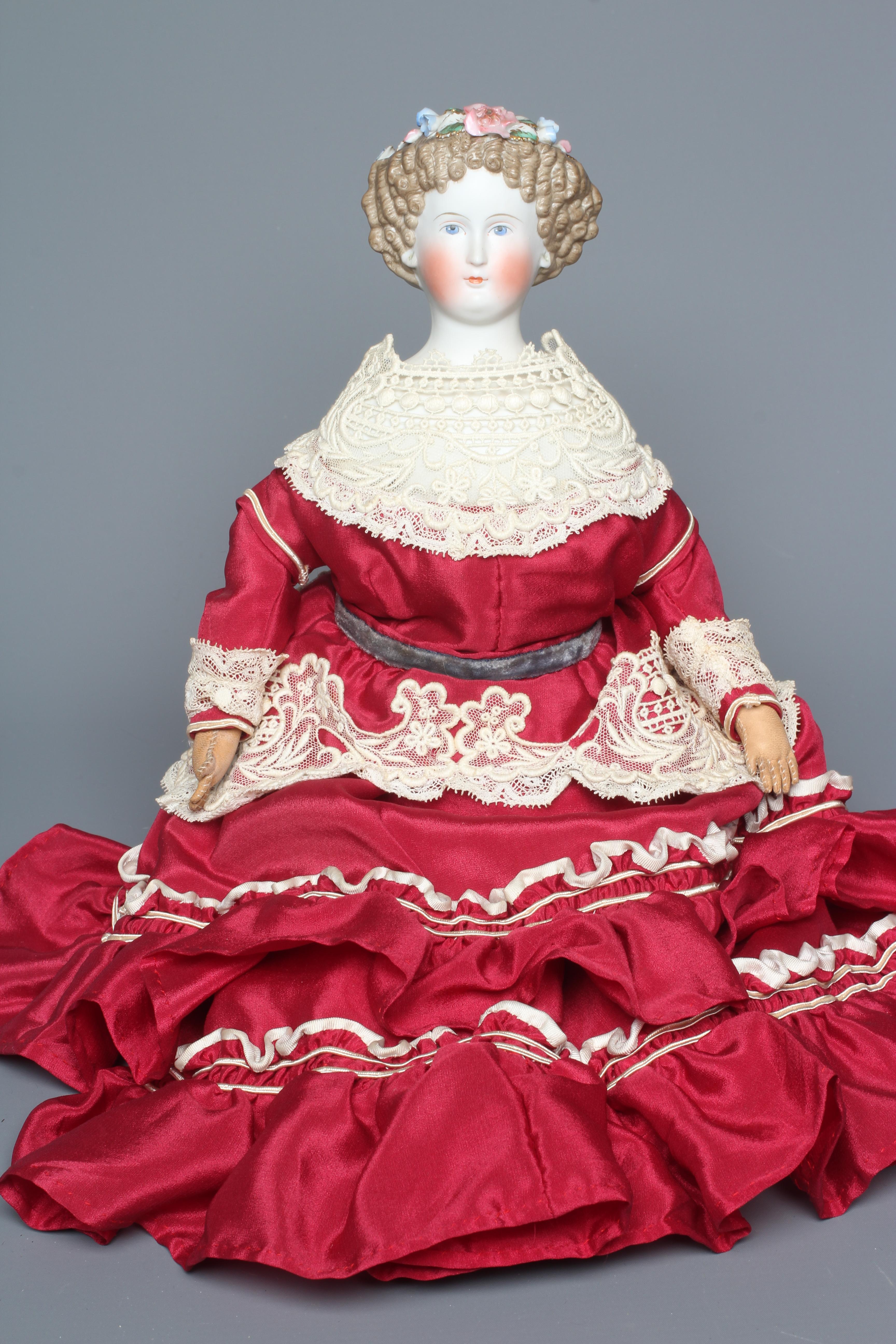 A bisque shoulder head doll, possibly Dornheim, with moulded hair encrusted with flowers, painted Image
