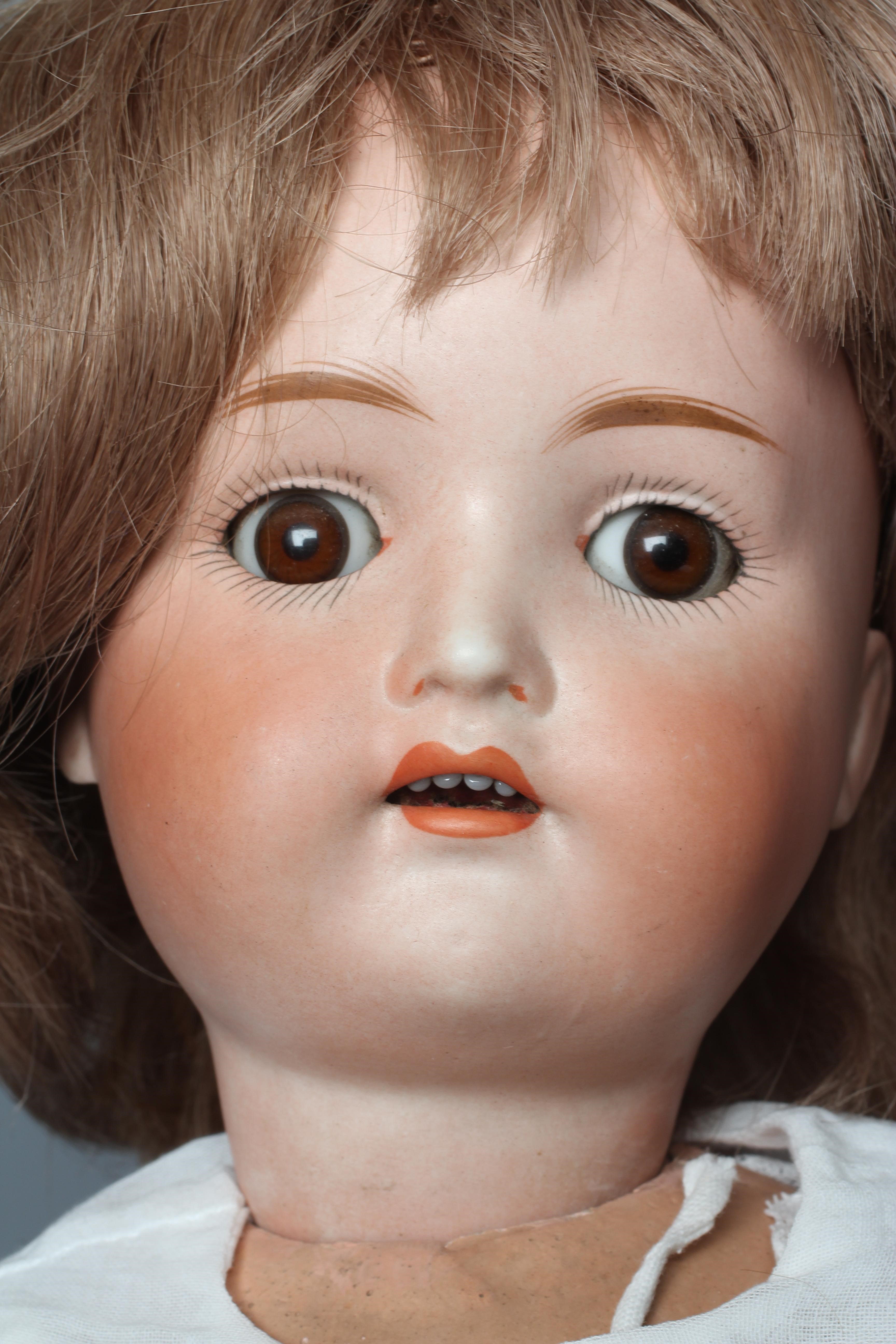 A Kestner bisque socket head doll, with brown glass sleeping eyes, open mouth, applied teeth, wood Image