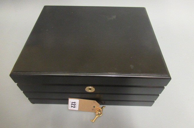 A large black adorini humidor with two keys Image