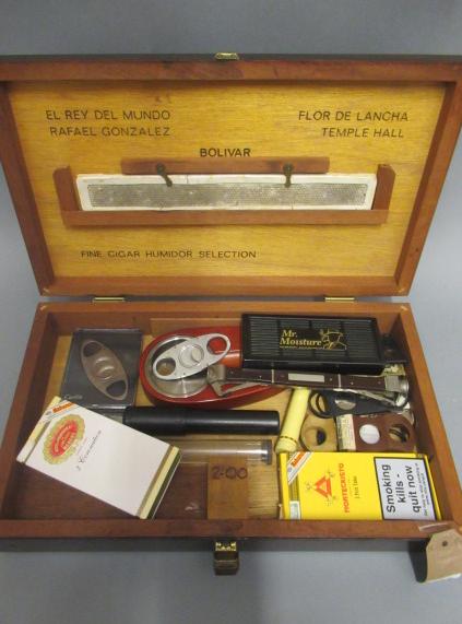 A 1950s bar top humidor containing 3 stainless steel cigar cutters Image