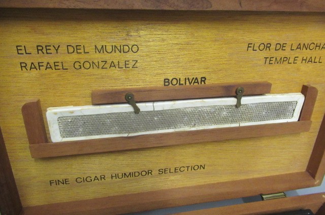 A 1950s bar top humidor containing 3 stainless steel cigar cutters Image