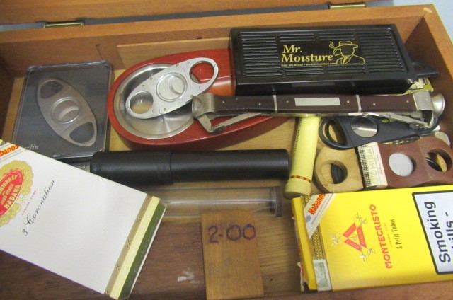 A 1950s bar top humidor containing 3 stainless steel cigar cutters Image
