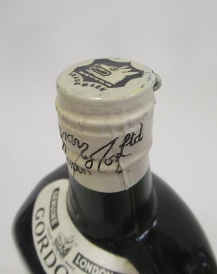 4 bottles of Gordons gin comprising 1 vintage 26.6fl.oz. snap cap top bottle Image