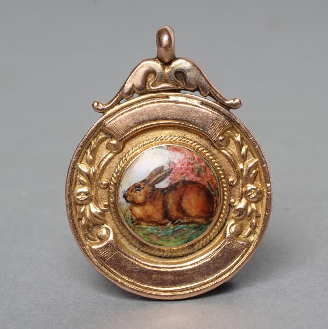 A 9CT GOLD FOB centred by a roundel enamelled with a rabbit Image