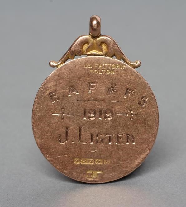 A 9CT GOLD FOB centred by a roundel enamelled with a rabbit Image