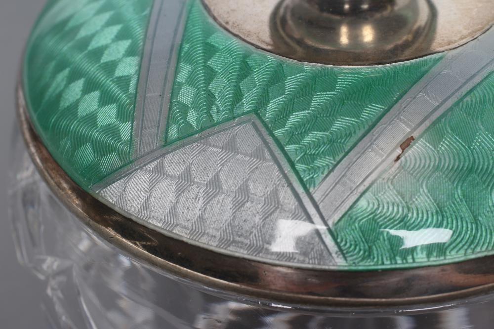 AN ART DECO CIRCULAR GLASS DRESSING TABLE JAR with silver cover Image