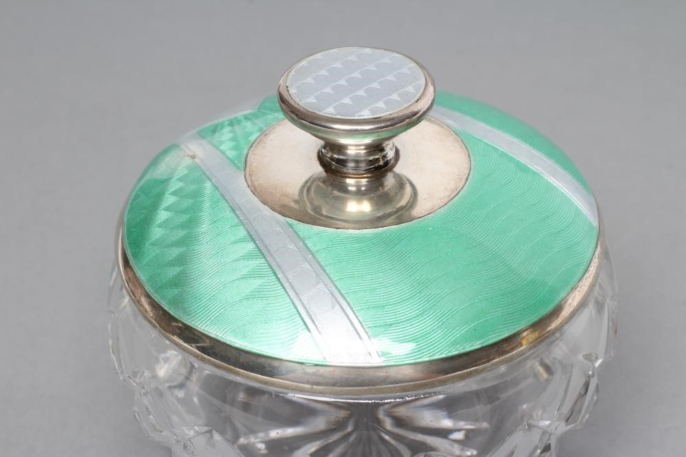 AN ART DECO CIRCULAR GLASS DRESSING TABLE JAR with silver cover Image