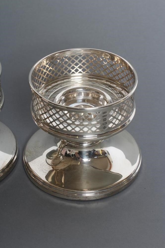 A PAIR OF SILVER CANDLE HOLDERS Image