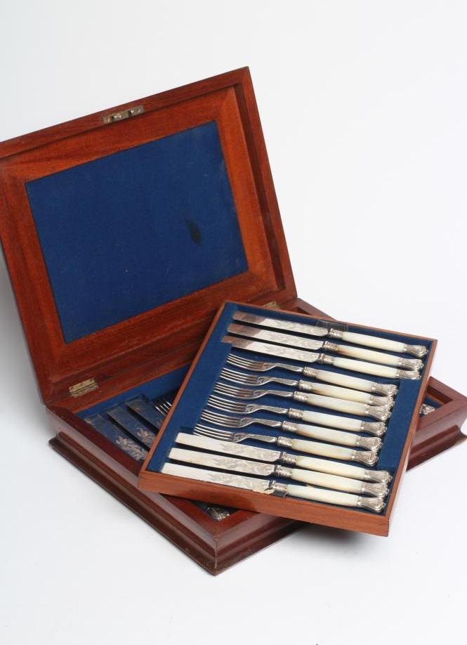 A SET OF TWELVE PAIRS OF VICTORIAN EPNS DESSERT KNIVES AND FORKS with scroll engraved blades and Image
