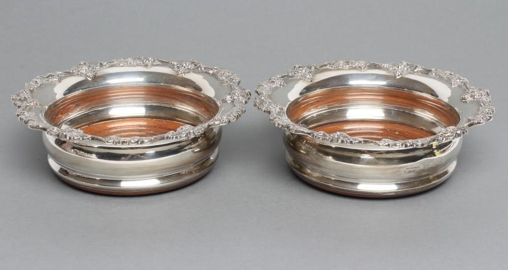 A PAIR OF GEORGIAN STYLE SILVER BOTTLE COASTERS Image