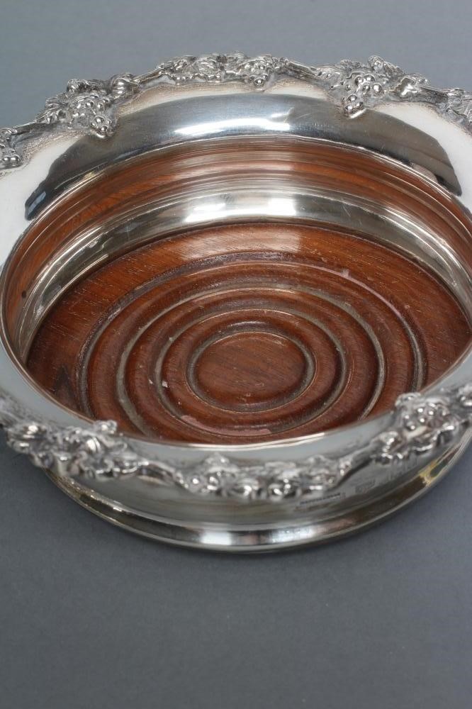 A PAIR OF GEORGIAN STYLE SILVER BOTTLE COASTERS Image