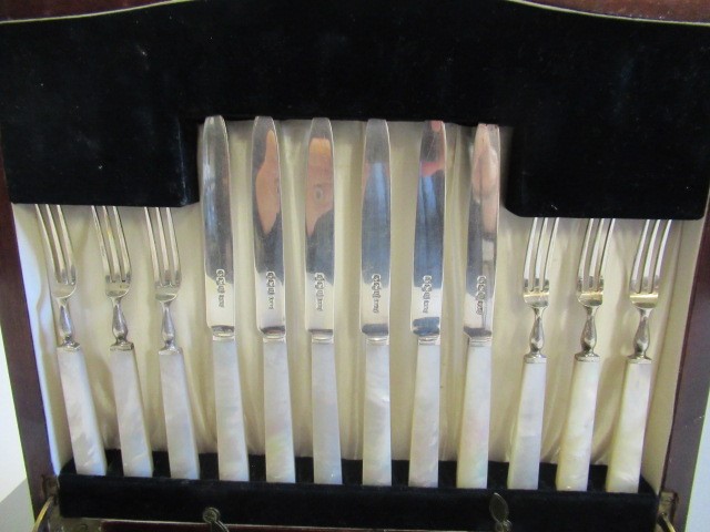 A SET OF TWELVE PAIRS OF SILVER FRUIT KNIVES AND FORKS Image