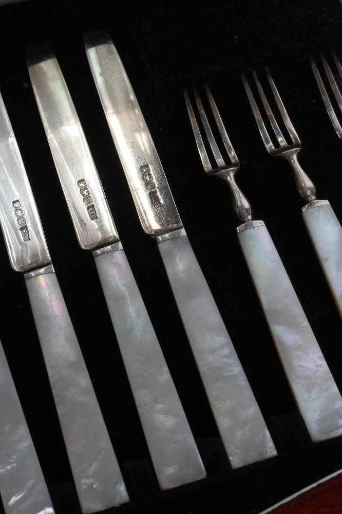 A SET OF TWELVE PAIRS OF SILVER FRUIT KNIVES AND FORKS Image