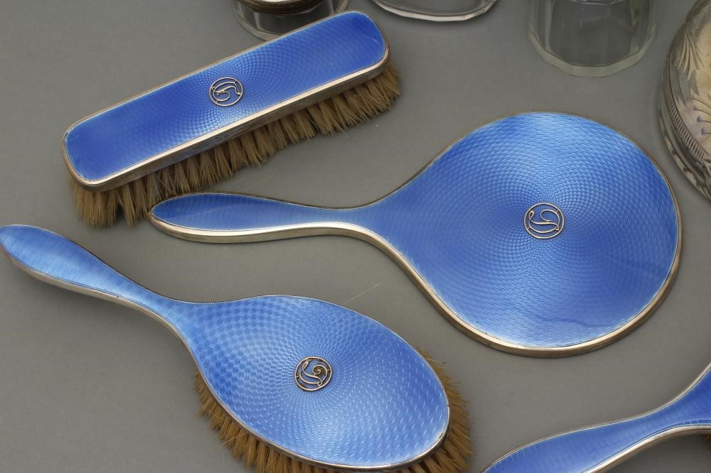 A COMPOSITE ART DECO SEVEN PIECE DRESSING TABLE SET Image