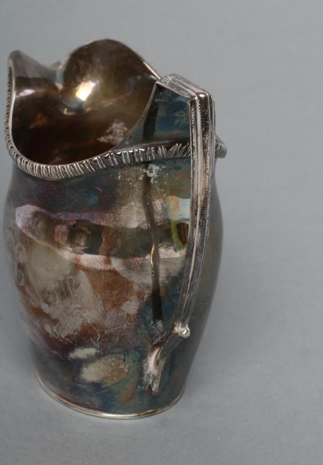 A GEORGE III SILVER MILK JUG Image