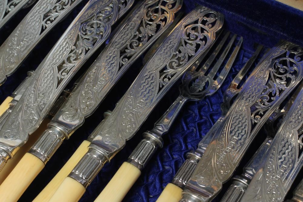 A SET OF TWELVE PAIRS OF EDWARDIAN SILVER FISH KNIVES AND FORKS Image