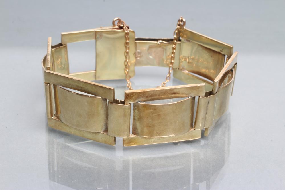 A BRACELET made up of five buckle panels to a plain oblong slide claps with safety chain Image