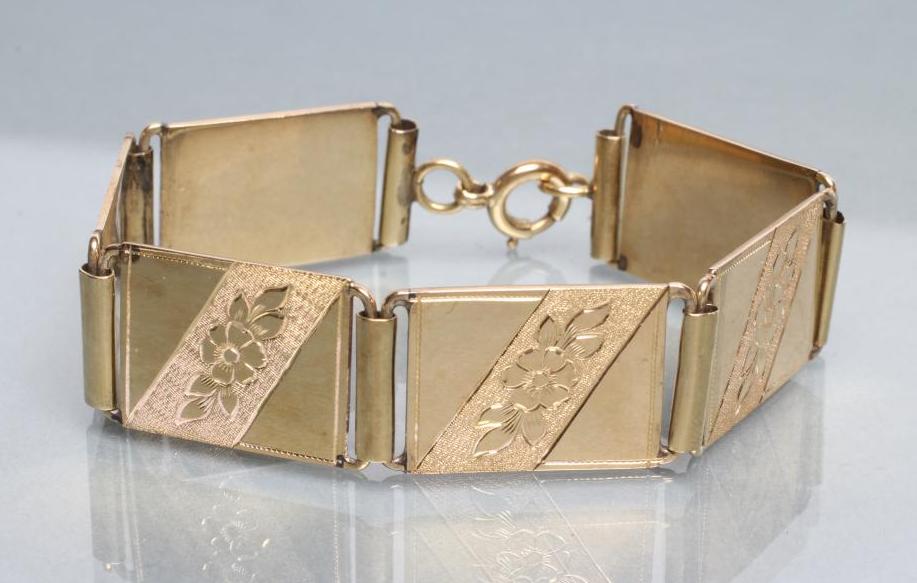 A BRACELET made up of six oblong panels engraved with flowers Image
