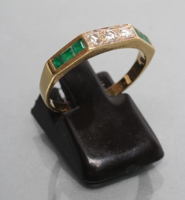 AN EMERALD AND DIAMOND HALF HOOP RING Image