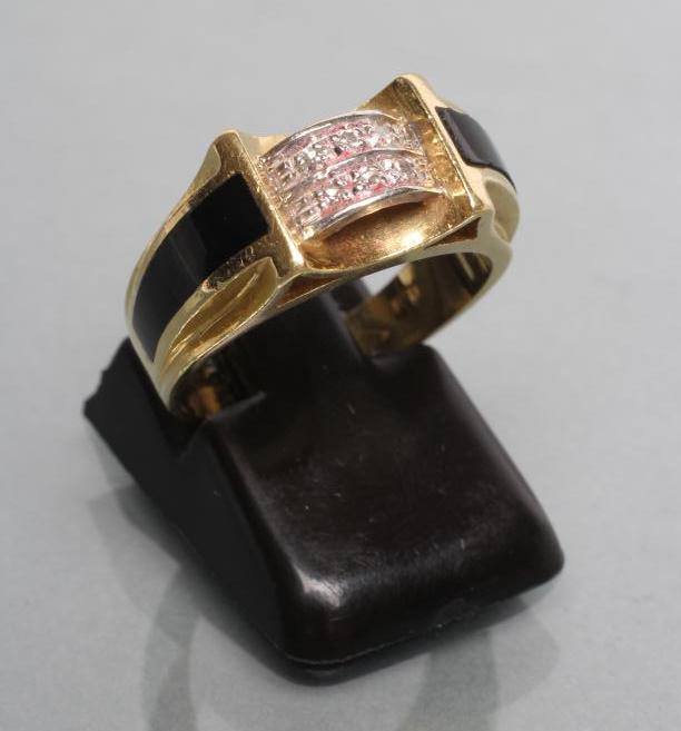 A DIAMOND AND ONYX RING Image