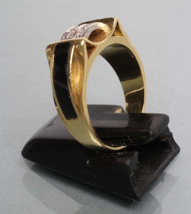 A DIAMOND AND ONYX RING Image
