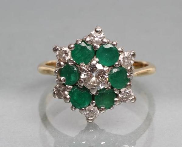 A DIAMOND AND EMERALD CLUSTER RING Image