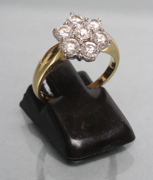 A SEVEN STONE DIAMOND CLUSTER RING Image