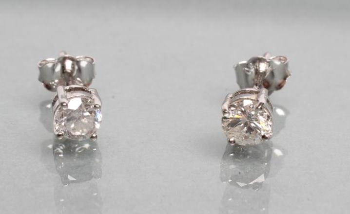 A PAIR OF DIAMOND SOLITAIRE EAR STUDS Image