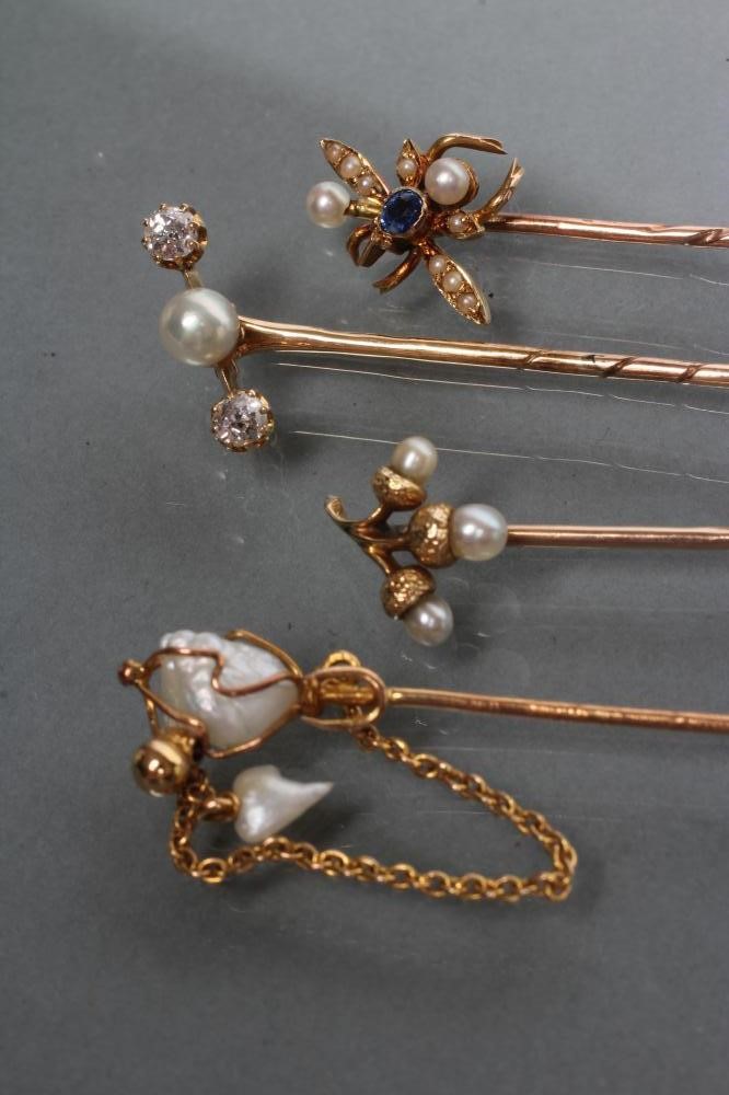 A COLLECTION OF FOUR VICTORIAN AND LATER STICK PINS including a fly with sapphire head and seed Image