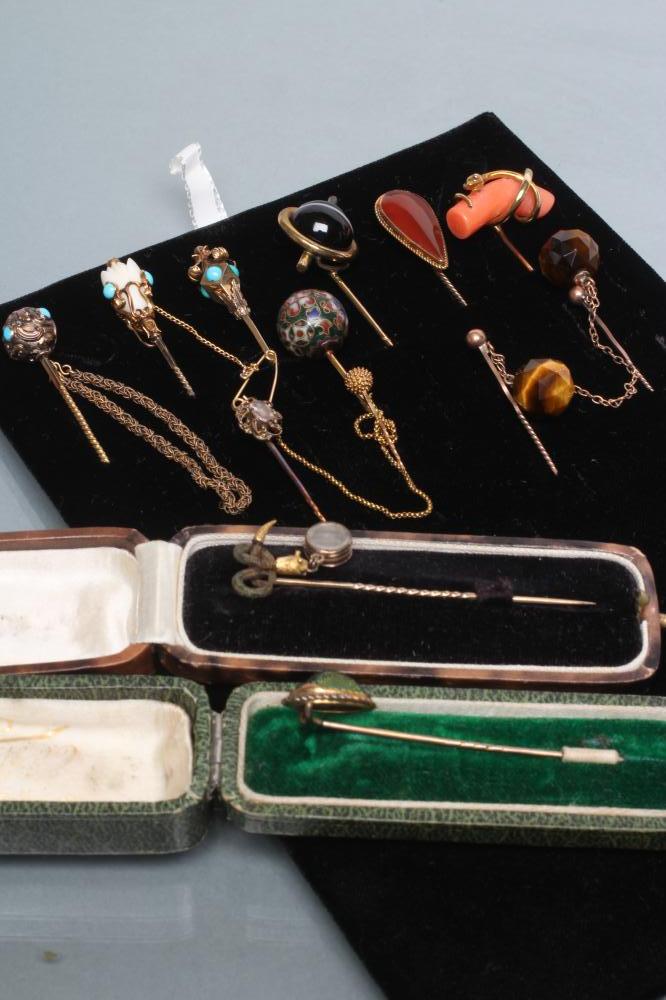 A COLLECTION OF NINE VICTORIAN AND LATER STICK PINS including a scarab Image