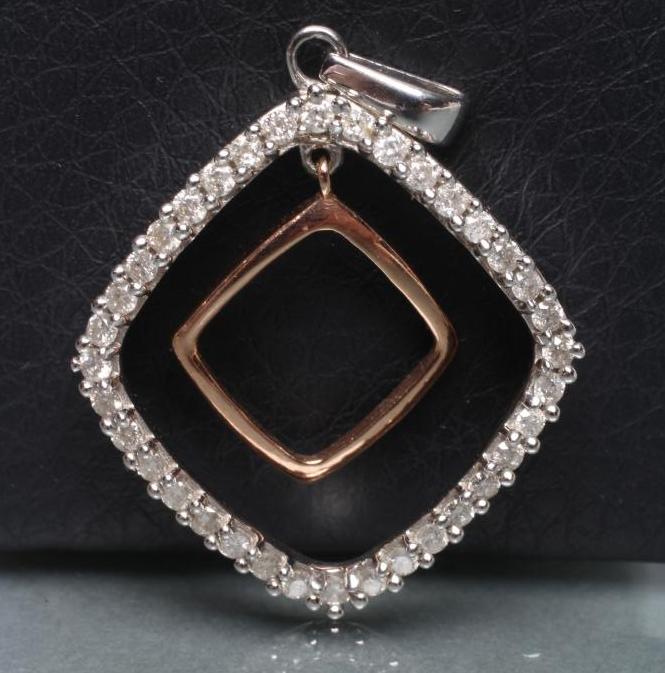 A BI-COLOUR 9CT GOLD PENDANT of open quatrefoil form Image