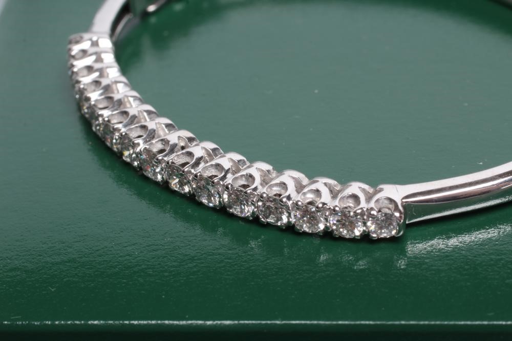 A DIAMOND STIFF HINGED BANGLE Image