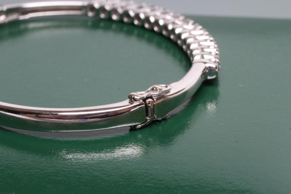 A DIAMOND STIFF HINGED BANGLE Image