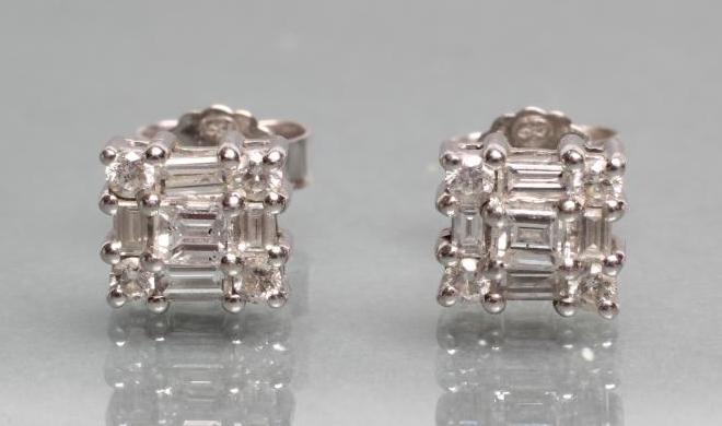 A PAIR OF DIAMOND EAR STUDS of oblong form set with a baguette and brilliant cut stones Image
