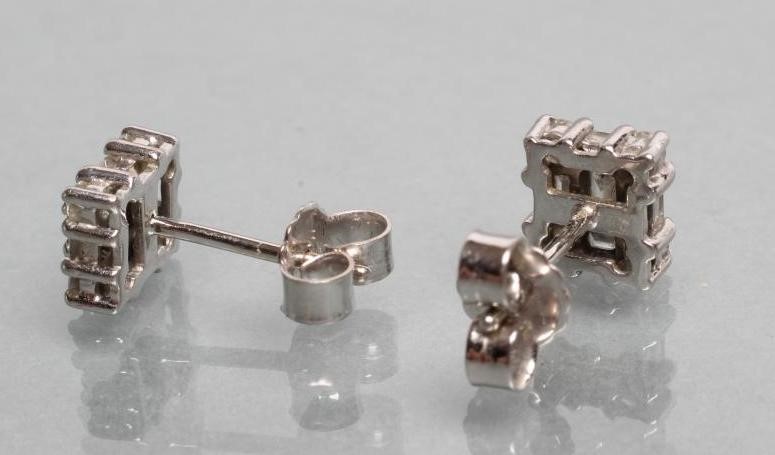 A PAIR OF DIAMOND EAR STUDS of oblong form set with a baguette and brilliant cut stones Image