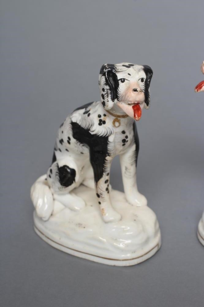 A PAIR OF STAFFORDSHIRE PORCELANEOUS BLACK AND WHITE SPANIELS Image