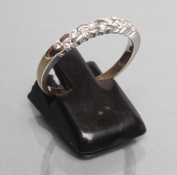 A DIAMOND HALF HOOP RING Image