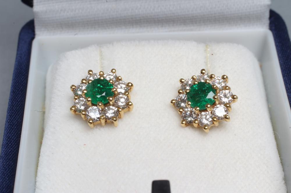 A PAIR OF EMERALD AND DIAMOND CLUSTER EAR STUDS Image