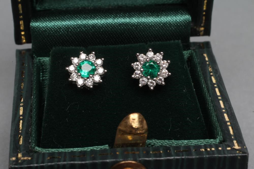 A PAIR OF EMERALD AND DIAMOND CLUSTER EAR STUDS Image