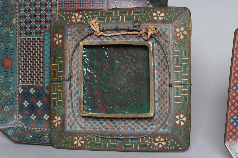 TWO CHINESE CLOISONNE ENAMEL SQUARE TRAYS with canted angles inlaid in sombre colours Image