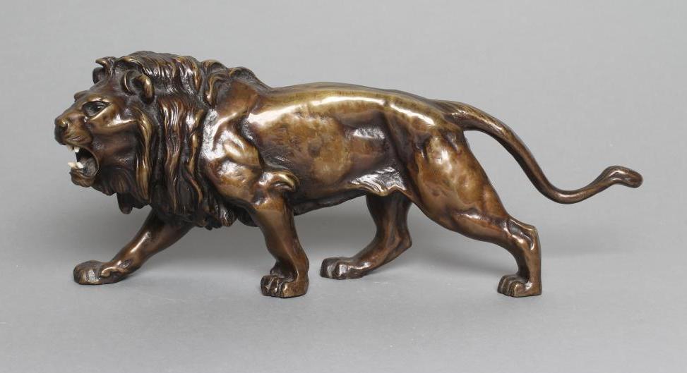A BRONZE MODEL OF A ROARING LION modelled standing Image