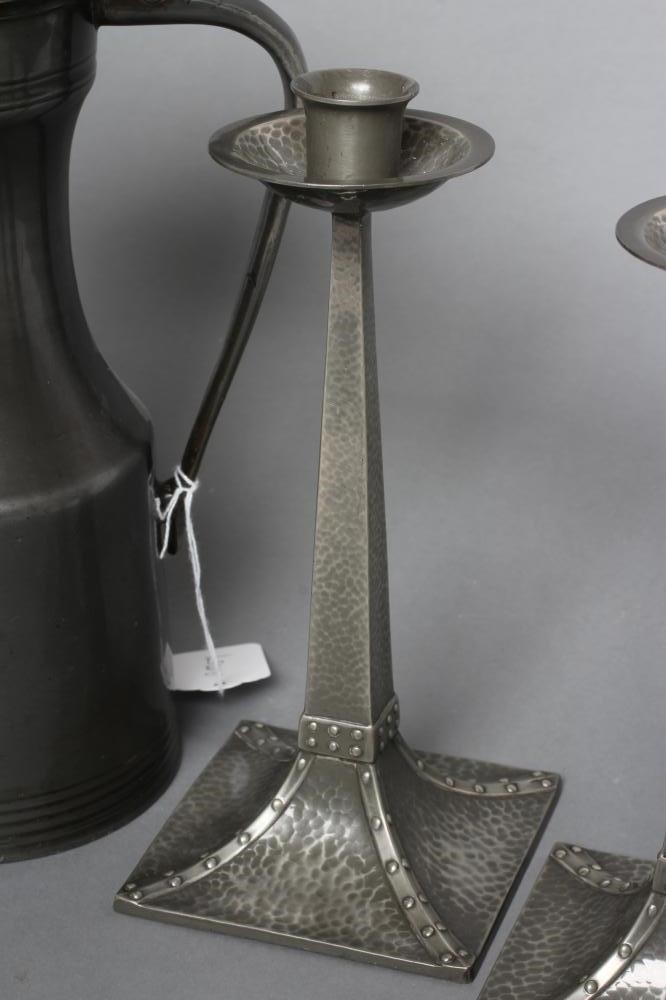 A PAIR OF "CORNISH" PEWTER ARTS AND CRAFTS STYLE CANDLESTICKS by James Dixon Image