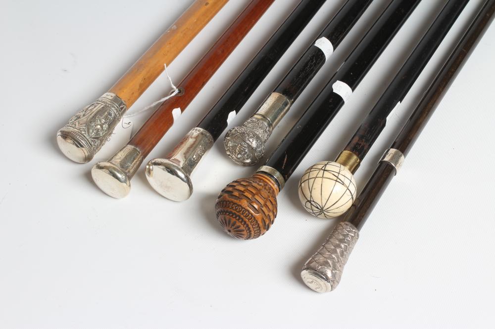 AN EBONISED WALKING CANE with carved wood ball grip Image