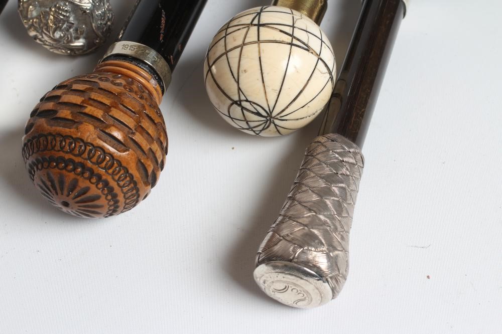 AN EBONISED WALKING CANE with carved wood ball grip Image